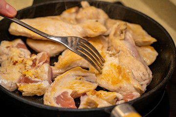 Pieces of chicken breast with a golden crust are fried in a pan. Protein-rich healthy food. Diet food at home.