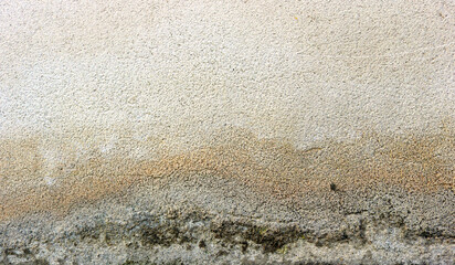 texture of wet white wall with yellow, gray and green humidity marks down - moisture backgrounud surface	