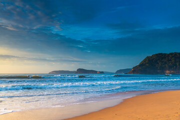 Fototapeta premium Early morning seascape with surfers