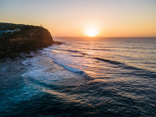 Aerial sunrise seascape with hazy blue sky
