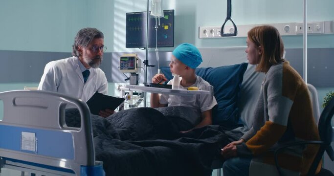 Doctor speaking with mother and eating little patient