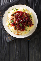 Poronkaristys Sauteed Reindeer, Mashed Potatoes and Lingonberries close-up in a plate on the table....