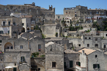 Fototapeta na wymiar Sassi di Matera historic site cityscape with ancient cave dwellings, popular tourist travel place, guided tour concept, Basilicata, Italy