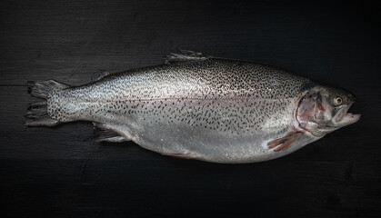 Fresh raw salmon red fish on a black wooden table. Creative layout made of fish, seafood, top view, flat lay