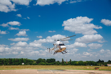 White helicopter takes off from the take-off area