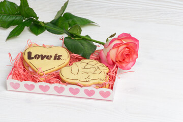 Gift wrap with heart shaped cookies and red rose