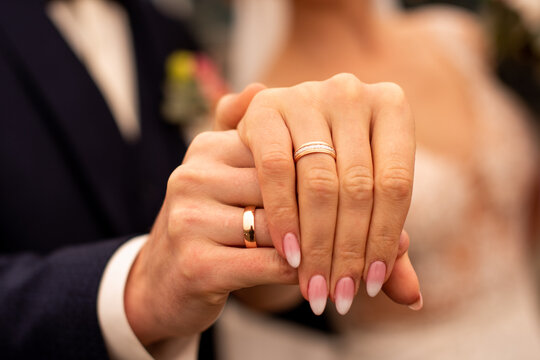 Picture of man and woman with wedding ring holding fingers