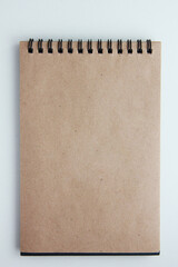 blank notebook with craft paper on white background