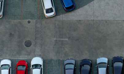 Top view concrete car parking lot. Aerial view of car parked at car parking area of apartment....
