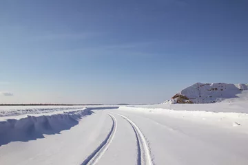 Fotobehang Ice road - travel north. Winter road is a winter road in the north.  © Илья Юрукин