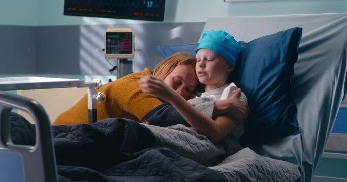 Mother hugging son in hospital ward