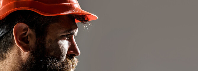 Man builders, industry. Builder in hard hat, foreman or repairman in the helmet. Bearded man worker with beard in building helmet or hard hat. Portrait builder, engineer working