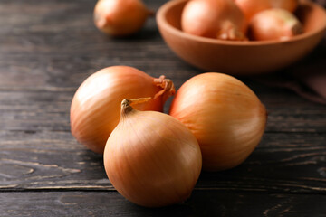 Ripe fresh onion on wooden background, close up