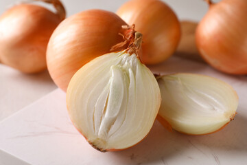 Marble board with fresh ripe onion, close up