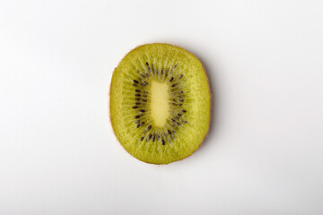 A piece of juicy kiwi fruit on a white background. Isolated kiwi close-up on a white background. Top view.