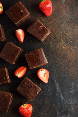 Pieces of chocolate brownie with strawberries