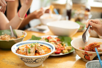 A Bowl of Tomyum Spicy noodle soup with blur background