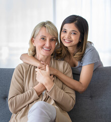 Happy teen girl embracing foster mother