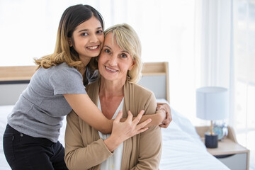 Caressing woman embracing adopted daughter
