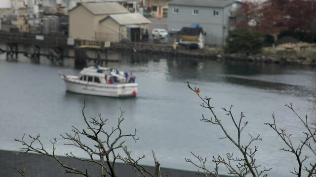 Thea Foss Waterway In Tacoma with cruising boats and ships during sunny day. Blurred shot out of focus.
