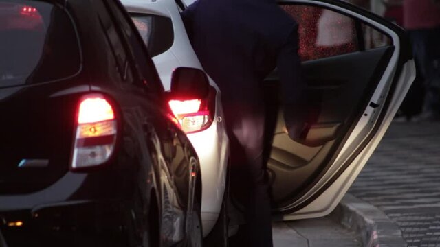 Businessman with luggage entering in a taxi in Brazil S&atilde;o Paulo