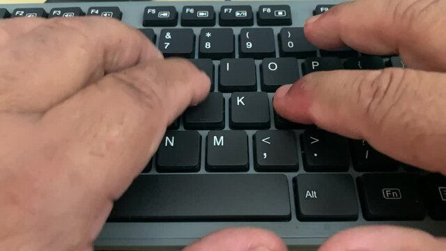 Typing a business letter on a computer keyboard in the office