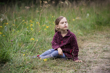 Lovely little girl playing in the summer field