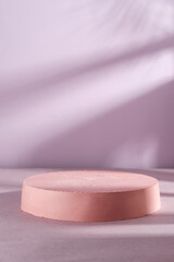 Geometric shapes pedestal on sea pink background. Mockup for product presentation with shadow.