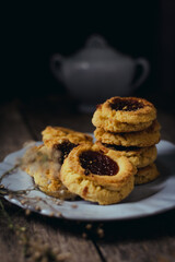 Quince cookies on rustic wooden board and black background