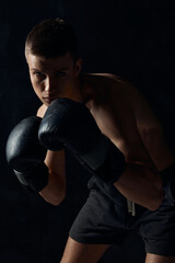 Fototapeta na wymiar man in boxing gloves on black background workout bodybuilder fitness