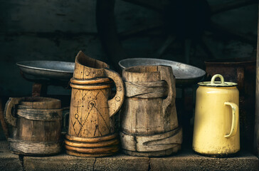 Old wooden beer mugs and jugs. Rustic antique tableware