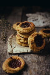 Quince cookies on rustic wooden board and black background