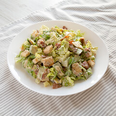 Homemade Bacon Avocado Caesar Salad with Cheese and Croutons, low angle view.