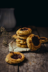 Quince cookies on rustic wooden board and black background