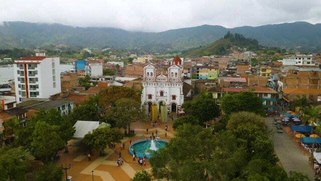 Downtown Guatape on a Cloudy Day. Aerial View of White Church and Plaza de Los Zocalos