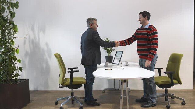 Llama crossing a scene of a business interview meeting between two men.