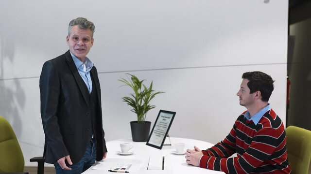 Llama passing a business interview meeting between two men.