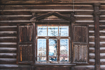 windows with wooden carvings on the windows in a wooden house. traditional ornament