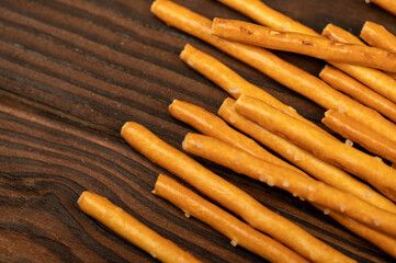 Salted bread strips scattered on a wooden table