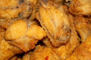 Small pieces of chicken meat with spices fried in breadcrumbs.