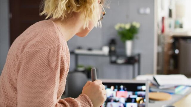 Video of female teacher writing on the blackboard while homeschooling. Shot with RED helium camera in 8K