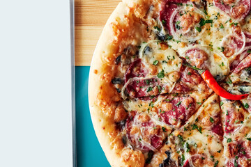 pizza in a plate on a wooden brown table top view