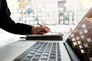 business woman working project, planning strategy, taking notes in modern office. University...