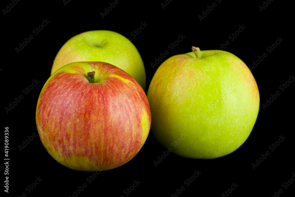 Poster apples isolated on a black background close-up.