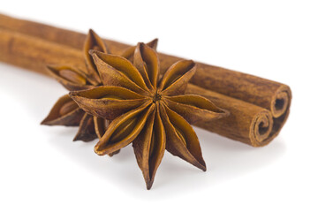 Anise stars and cinnamon stick isolated on white background close-up.