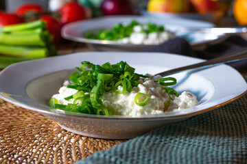 cottage cheese with spring onions on a plate
