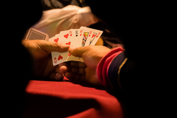 The player is holding a card in his hand for gambling games.