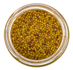 Mustard in a jar isolated on white background close-up.