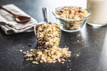 Beakfast cereals in scoop. Healthy muesli with oat flakes, nuts and raisins