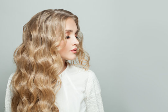 Premium Photo  Beautiful blonde woman hairstyle long smooth curly hair  fashion makeup studio shot